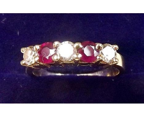 An 18 carat gold ring set rubies and diamonds, size N