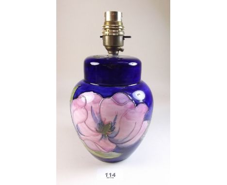 A Moorcroft table lamp painted magnolia on a blue ground - 22cm