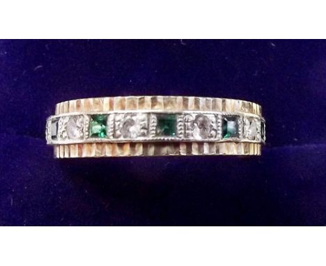 A 9 carat gold emerald and white stone eternity ring - size N