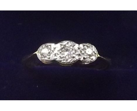 An 18 carat gold and platinum three stone diamond ring - size K