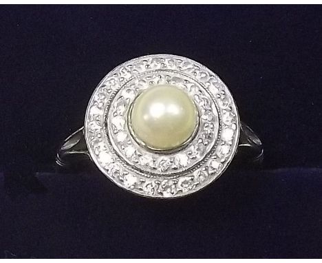 A platinum vintage cluster ring set pearl within double band of diamonds