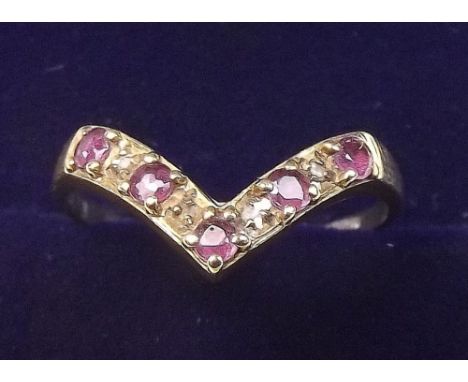 A 9 carat gold ruby and chip diamond ring, size L