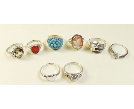 Seven silver rings and a turquoise set gilt white metal ring