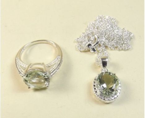 A silver ring set green amethyst and a pendant