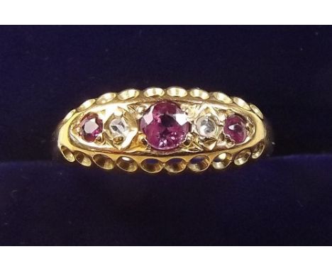 An 18 carat gold ruby and chip diamond gypsy ring - size 0