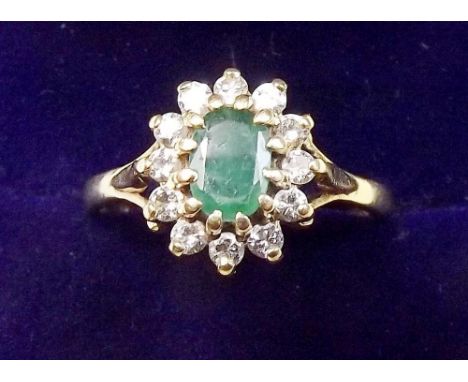 An 18 carat gold emerald and diamond cluster ring - size O