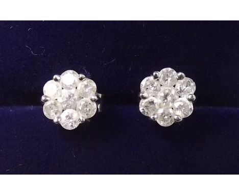 A pair of rhodium plated 9 carat gold diamond cluster earrings (with silver backs)