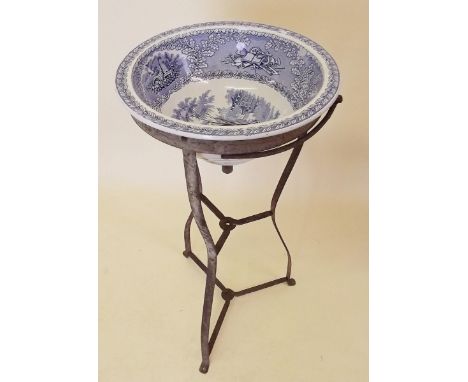 A 19th century blue and white pottery wash basin on metal stand