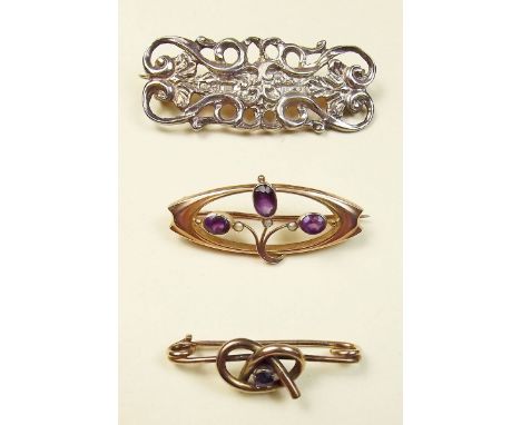 An Edwardian 9 carat gold brooch set amethyst and seed pearls and two other brooches