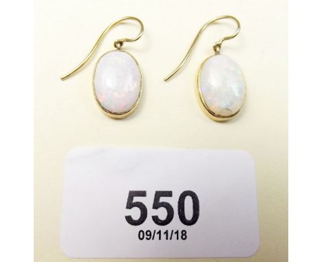 A pair of opal and gold drop earrings