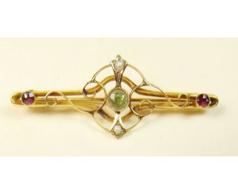 An Edwardian gold brooch set peridot and amethyst