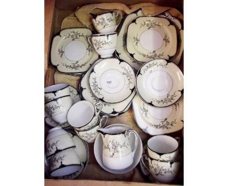 A Noritake tea service decorated blossom on a yellow ground, comprising ten cups and saucers, twelve tea plates, milk and sug