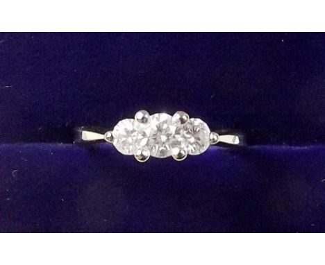 An 18 carat gold three stone diamond ring, size  I