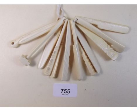 A set of carved bone miniature tools