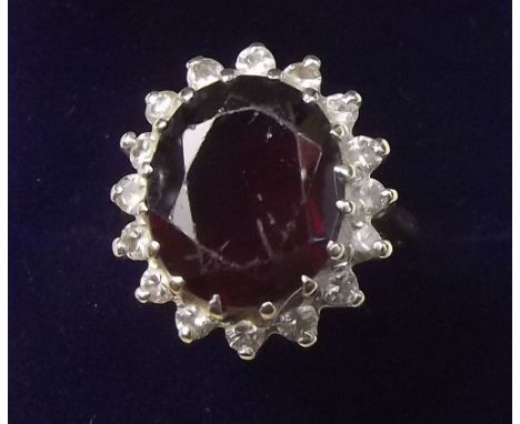 An 18 carat gold diamond and garnet cluster ring - size N