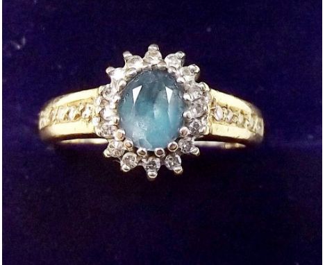 A 9 carat gold diamond and blue topaz ring, size K