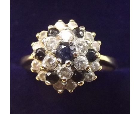 A 9 carat gold sapphire and white stone ring