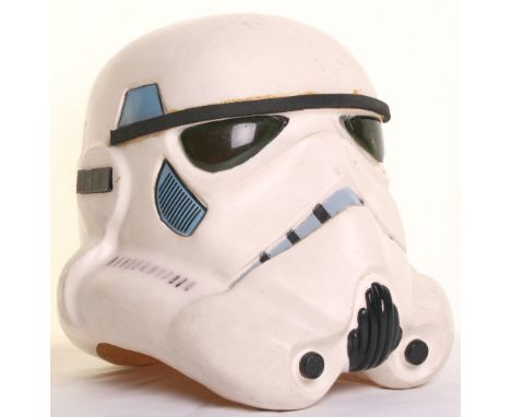 Star Wars Imperial Stormtrooper Helmet circa 1977, being a very crudely made white vacuum formed plastic helmet with green ey