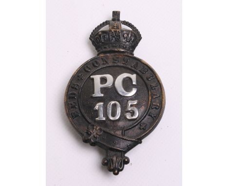 Beds Constabulary Helmet Badge, Kings crown,  black garter, Chrome ‘PC 105’ centre, complete with three rear fixing lugs 