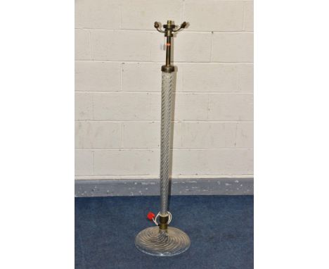 AN EARLY 20TH CENTURY MURANO STYLE GLASS STANDARD LAMP, two bulb brass fitting on a graduating spiral twist column and circul