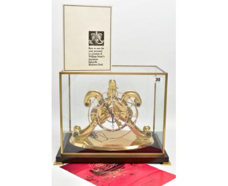 AN EMPEROR CLOCK COMPANY BRASS EPICYCLIC CLOCK UNDER RECTANGULAR GLAZED CASE, with wooden base, comes with pendulum, key, ord