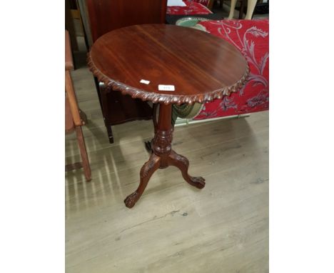 A HEAVILY CARVED OCCASIONAL TABLE ON TRIPOD STAND WITH CLAW AND BALL FEET