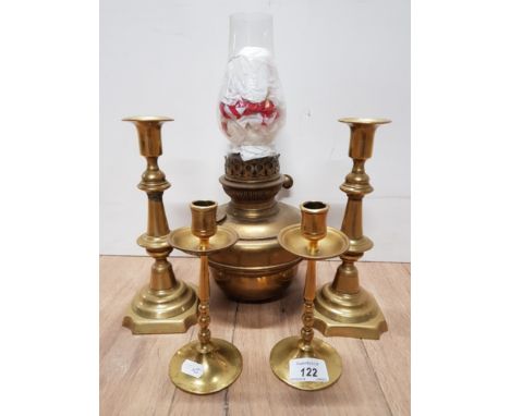 BRASS OIL LAMP WITH GLASS CHIMNEY AND TWO PAIRS OF BRASS CANDLESTICKS