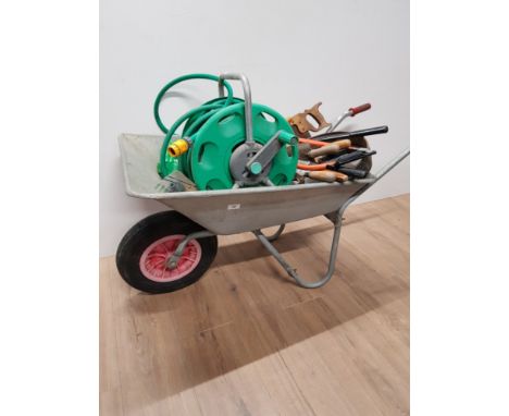GARDEN WHEELBARROW WITH GARDEN TOOLS AND HOSE ON REEL