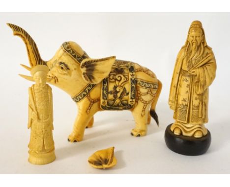 CHINESE CARVED IVORY ELEPHANT
in ceremonial attire, 9.4cm high; Chinese carved bone Shinto priest holding a scroll, on a hard