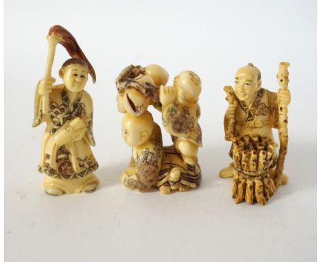 CHINESE CARVED IVORY NETSUKE
of two boys gathering fruit, with one standing on a tortoise, 5cm high; an ivory netsuke of a sc