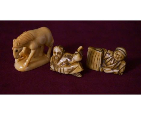 JAPANESE CARVED IVORY NETSUKE
of a horse and foal, signed to base, 4cm high; together with two ivory netsukes, one of a recli