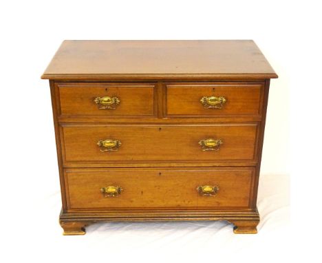 EDWARDIAN MAHOGANY CHEST
with two frieze drawers above two long drawers, all with decorative metal handles and standing on br