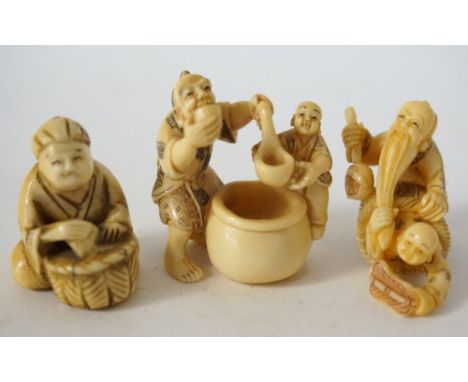 CARVED IVORY NETSUKE
of a father and son drinking from a large pot, 4cm high; ivory netsuke of a man seated with a basket 3.4