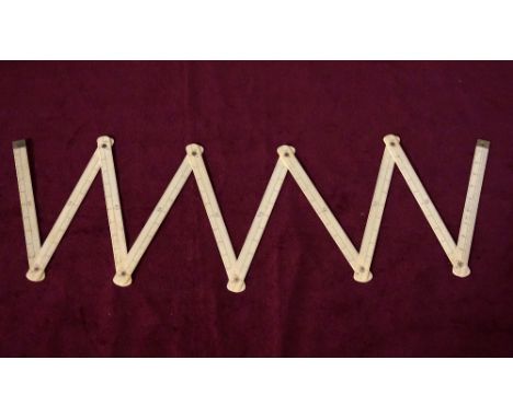 IVORY FOLDING STICK MEASURE
comprising ten articulated sections, with centimetre markings, total length 100cm
