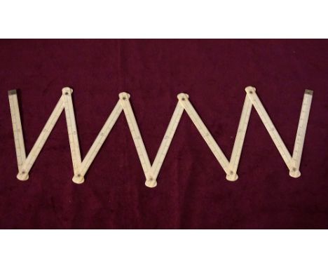 IVORY FOLDING STICK MEASURE
comprising ten articulated sections, with centimetre markings, total length 100cm