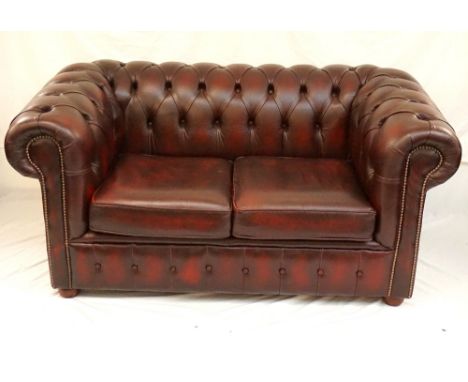 LEATHER CHESTERFIELD BUTTON BACK TWO-SEATER SOFA
in ox blood red leather with stud detail, raised on bun feet, 160cm wide 