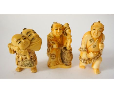 CARVED IVORY NETSUKE
of a man holding a fan with a bag over his shoulder, 6.2cm high; a carved ivory netsuke of a basket sell