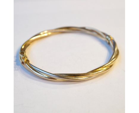 TWO TONE NINE CARAT GOLD BANGLE
of twisted design, approximately 6.6 grams