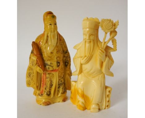 CHINESE CARVED IVORY FIGURE 
of a deity seated holding flowers, 10.5cm high; and a Chinese carved ivory figure of a deity hol