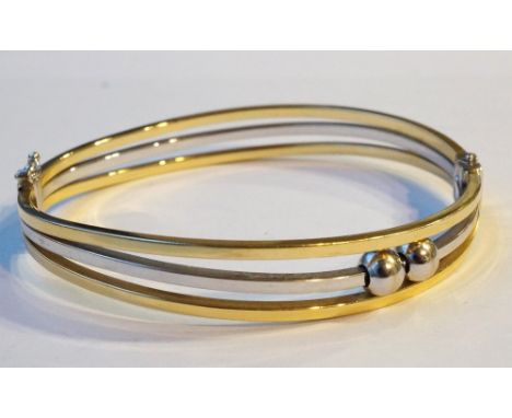 TWO TONE EIGHTEEN CARAT GOLD BANGLE
with ball detail, total weight approximately 16.7 grams