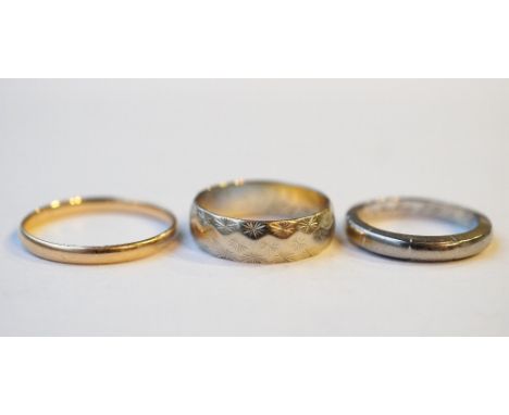 THREE EIGHTEEN CARAT GOLD RINGS
two with engraved decoration, ring sizes D, F-G and J-K, total weight approximately 6.5 grams