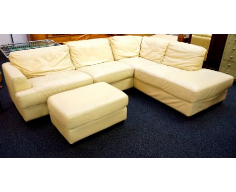 LARGE LEATHER CORNER SOFA
in cream leather, together with a matching footstool, all standing on shaped block supports 