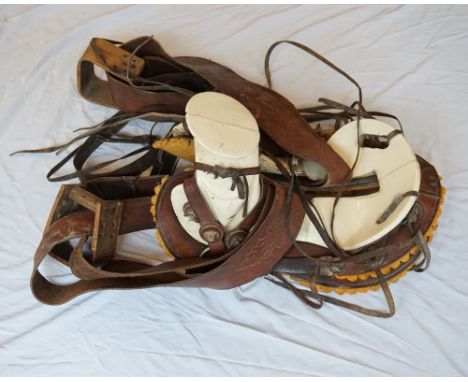 VINTAGE SPANISH HORSE SADDLE
with composition head and seat, leather skirt and strapping, with wooden stirrups