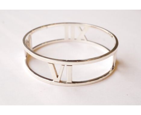 ATLAS TIFFANY & CO. STERLING SILVER BANGLE
the pierced bangle with Roman numerals III, VI, IX and XII
Note: RRP £795
