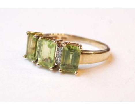 PERIDOT AND DIAMOND RING
the three emerald cut peridots separated by small diamonds, on nine carat gold shank, ring size K