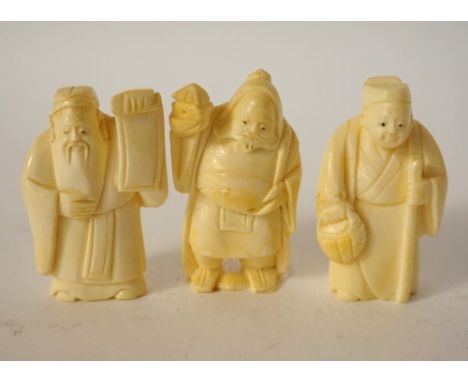 THREE JAPANESE CARVED IVORY NETSUKE
of scholars, 5.2cm, 5.4cm and 5.4cm high 