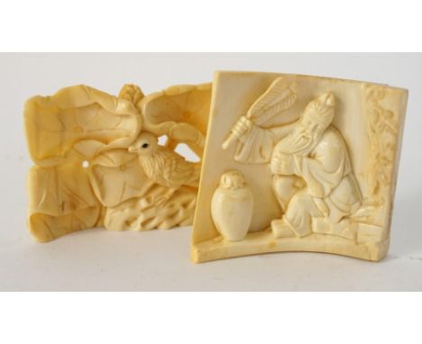 CARVED IVORY NETSUKE
of a sage seated by a cave with a fan and a lidded jar beside him, the reverse decorated with birds in a