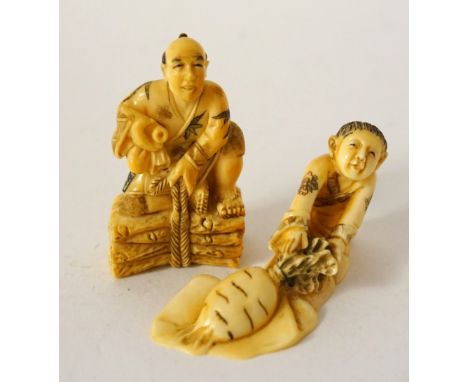 CARVED IVORY NETSUKE
of a man seated upon a stack of logs, 5cm high; and an ivory carving of a boy pulling a large turnip fro