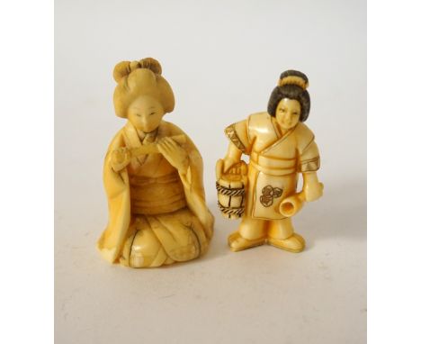 JAPANESE CARVED IVORY NETSUKE
of a geisha kneeling and playing the flute, 5.5cm high; and a Japanese ivory netsuke of a geish