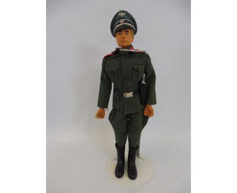 A 1970s Action Man with blond flock hair in a Geyper Man German staff officer's uniform.